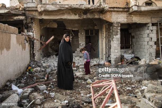 Family return to their destroyed home to search for their personal belongings. The city of Mosul in northern Iraq has been under ISIS control for 3...