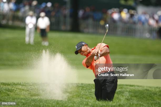 Tiger Woods hits out of bunker during the first round of the AT&T National hosted by Tiger Woods at Congressional Country Club on July 2, 2009 in...