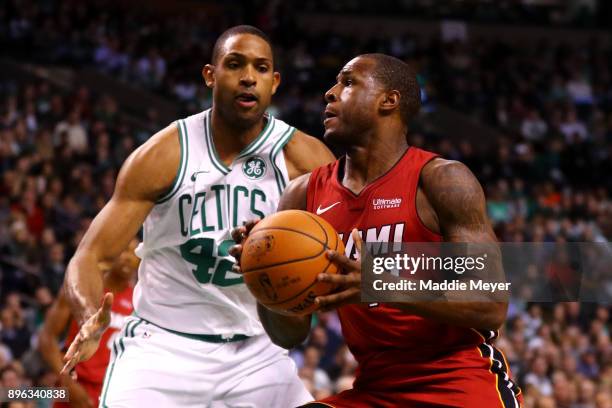 Dion Waiters of the Miami Heat drives against Al Horford of the Boston Celtics during the second quarter at TD Garden on December 20, 2017 in Boston,...