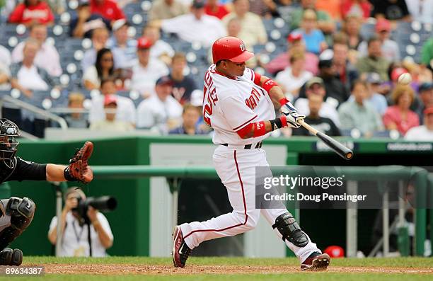 Alberto Gonzalez of the Washington Nationals hits a two run RBI against the Florida Marlins during their MLB game on August 6, 2009 at Nationals Park...