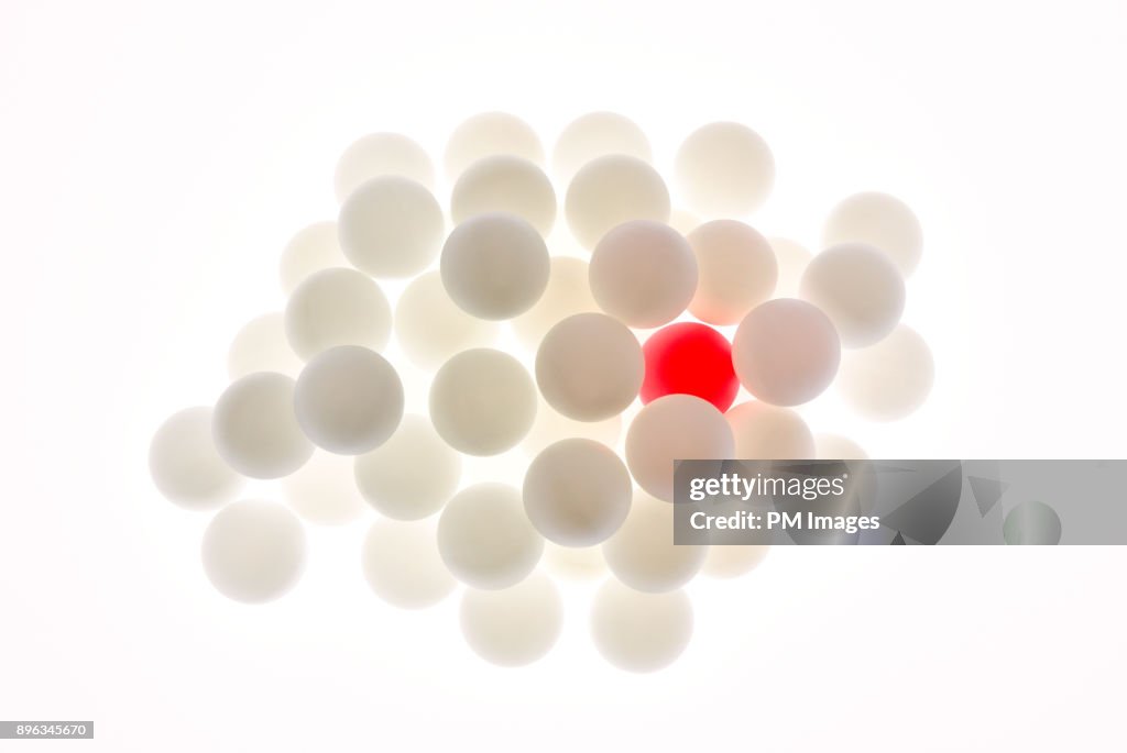 One red ball among many white balls