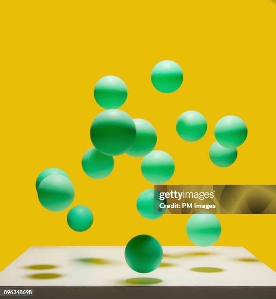 bunch of bouncing green balls - rebound stock pictures, royalty-free photos & images