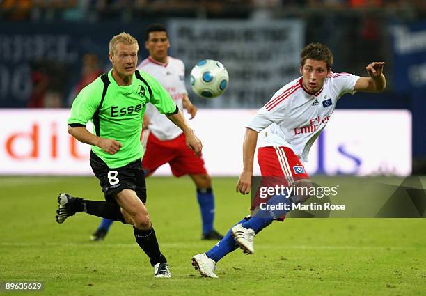 Tunay Torun of Hamburg and Soeren Pedersen of Randers compete for the ball during the UEFA Europa League second leg match between Hamburger SV and...