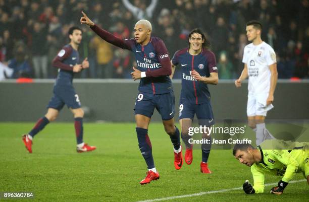 Kylian Mbappe of PSG celebrates his goal with Edinson Cavani while goalkeeper of Caen Remy Vercoutre lies down during the French Ligue 1 match...