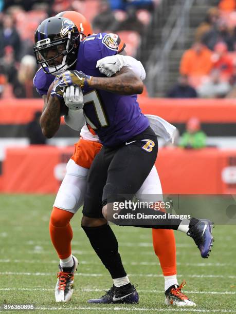 Wide receiver Mike Wallace of the Baltimore Ravens is tackled by cornerback Jason McCourty of the Cleveland Browns in the first quarter of a game on...