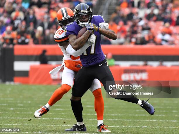 Wide receiver Mike Wallace of the Baltimore Ravens is tackled by cornerback Jason McCourty of the Cleveland Browns in the first quarter of a game on...