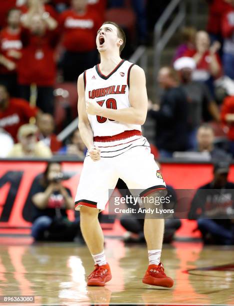 Ryan McMahon of the Louisville Cardinals celebrates after making a three point shot late in the game against the Albany Great Danes at KFC YUM!...