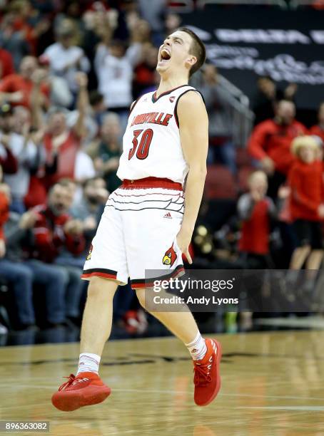 Ryan McMahon of the Louisville Cardinals celebrates after making a three point shot late in the game against the Albany Great Danes at KFC YUM!...