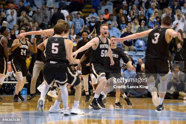 Matthew Pegram and Fletcher Magee of the Wofford Terriers celebrate with teammates following their win against the North Carolina Tar Heels at Dean...