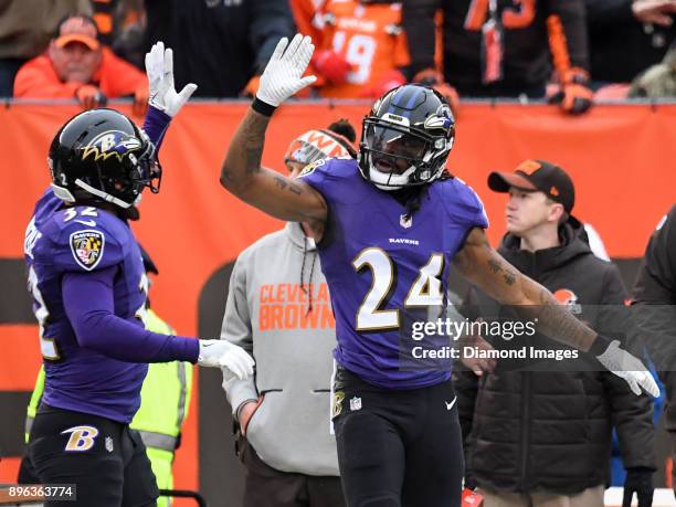 Cornerback Brandon Carr and safety Eric Weddle of the Baltimore Ravens celebrates an incomplete pass in the first quarter of a game on December 17,...