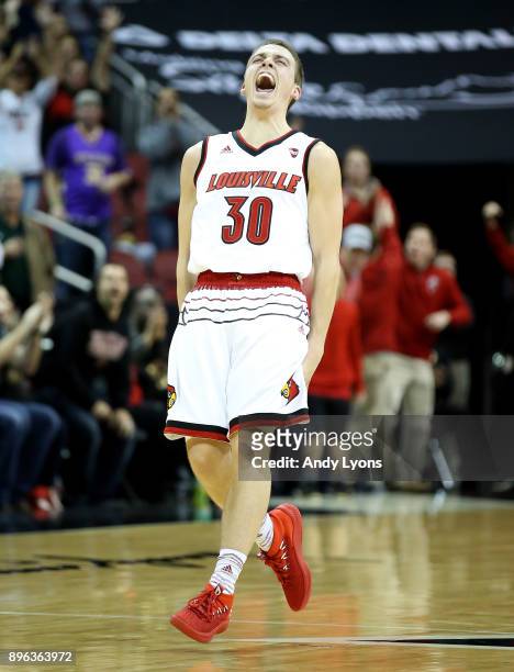 Ryan McMahon of the Louisville Cardinals celebrates after making a three point shot late in the game against the Albany Great Danes at KFC YUM!...