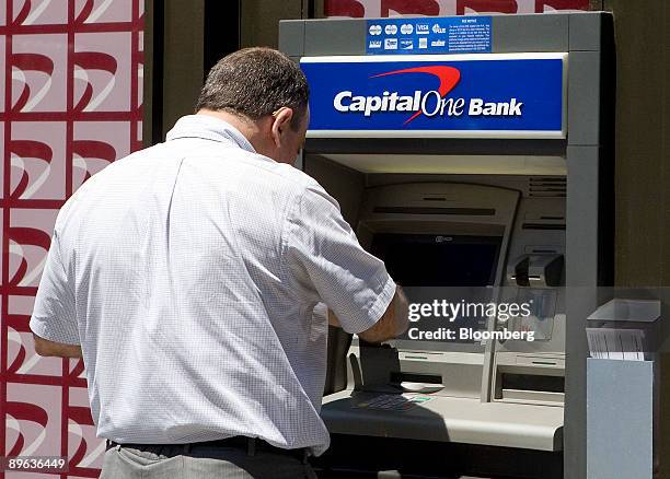 Man uses an automatic teller machine at a Capital One bank branch in New York, U.S., on Tuesday, June 30, 2009. Capital One Financial Corp's earnings...