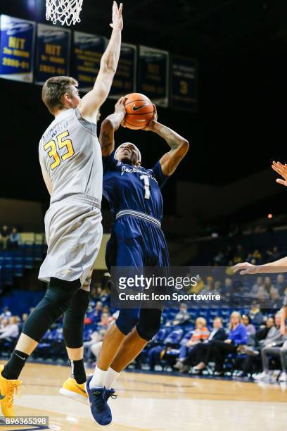 Jackson State Tigers guard Charles Taylor Jr. Goes in for a layup against Toledo Rockets forward Nate Navigato during a regular season non-conference...