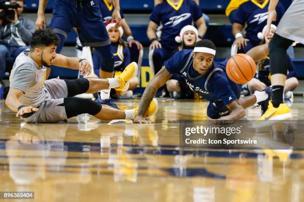 Toledo Rockets guard Justin Roberts and Jackson State Tigers guard Charles Taylor Jr. Scramble for a loose ball during a regular season...