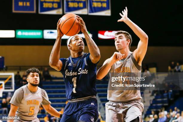 Jackson State Tigers guard Charles Taylor Jr. Goes in for a layup against Toledo Rockets forward Nate Navigato during a regular season non-conference...