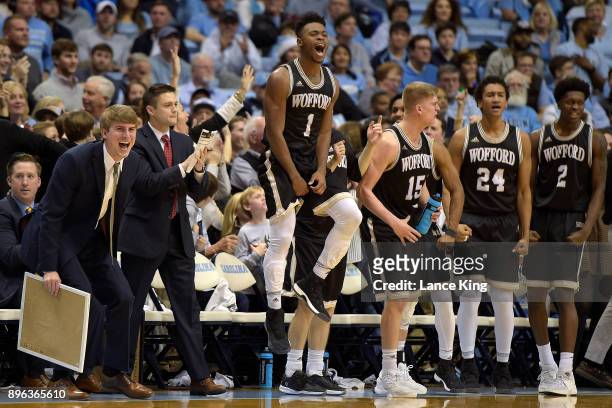 Derrick Brooks of the Wofford Terriers celebrates with teammates from their bench during their game against the North Carolina Tar Heels at Dean...