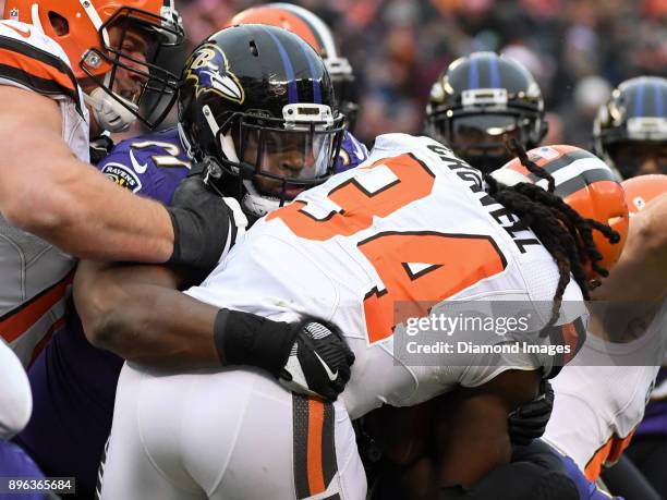 Defensive tackle Michael Pierce of the Baltimore Ravens tackles running back Isaiah Crowell of the Cleveland Browns in the first quarter of a game on...