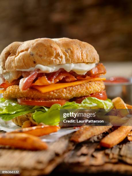 crispy chicken blt burger with fries - breaded chicken stock pictures, royalty-free photos & images