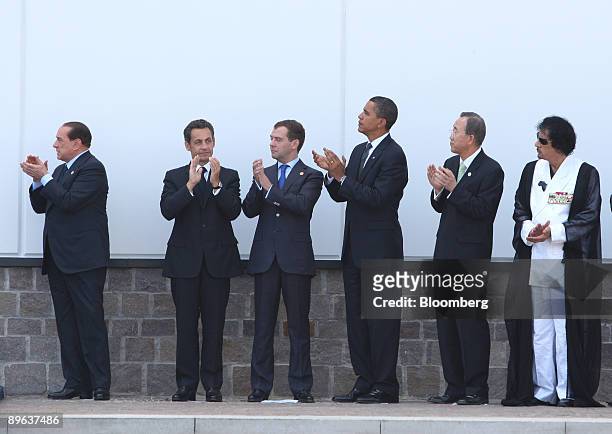 Silvio Berlusconi, Italy's prime minister, far left, applauds with, left to right, Nicolas Sarkozy, France's president, Dmitry Medvedev, Russia's...