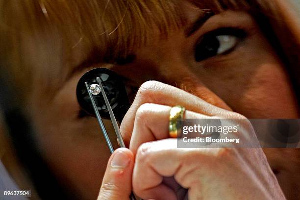 Beth Leinonen, a gemologist, examines a diamond for imperfections at a store run by Brilliant Earth, which uses conflict-free diamonds from Canadian...