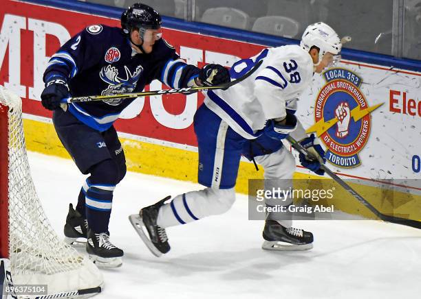 Colin Greening of the Toronto Marlies controls the puck against Kirill Gotovets of the Manitoba Moose during AHL game action on December 17, 2017 at...