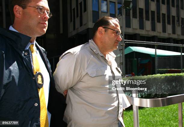 Michael Passaro is escorted by federal agents at Federal Plaza in New York, U.S., on Wednesday, July 8, 2009. The Federal Bureau of Investigation has...