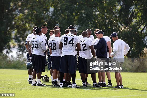 Assistant Head Coach/Defensive Line Dan Quinn talks with his players during training camp at the Seahawks training facility on July 31, 2009 in...