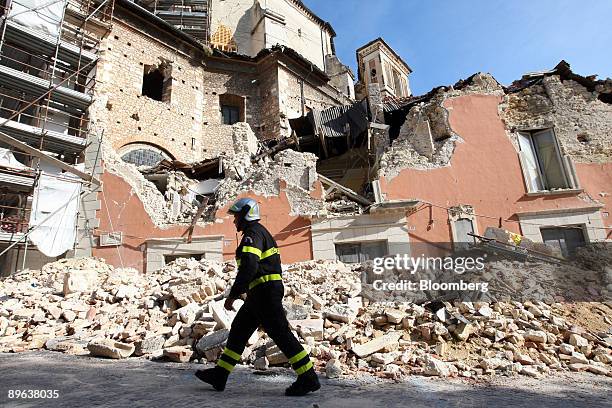 Fireman walks past a government building destroyed in an April earthquake in L'Aquila, Italy, on Wednesday, July 8, 2009. Group of Eight leaders said...