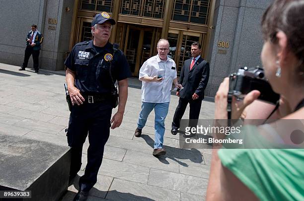 Reporter, center, rushes out of federal court after the sentencing of Bernard Madoff, founder of Bernard L. Madoff Investment Securities LLC, in New...