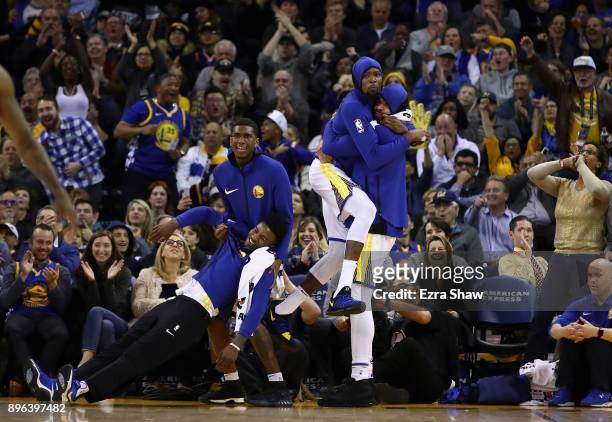 Jordan Bell, Kevon Looney, Kevin Durant and JaVale McGee of the Golden State Warriors celebrate after the Warriors made a basket against the Memphis...