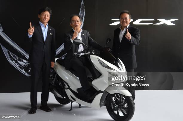 Toshiyuki Inuma , president director of P.T. Astra Honda Motor, an Indonesian manufacturing unit of Honda Motor Co., joins other company officials at...