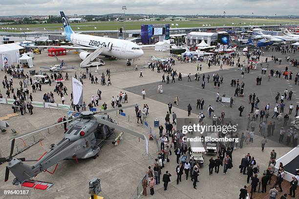 Visitors pass through the Paris Air Show in Le Bourget, France, on Thursday, June 18, 2009. The 48th International Paris Air Show runs from June 15...