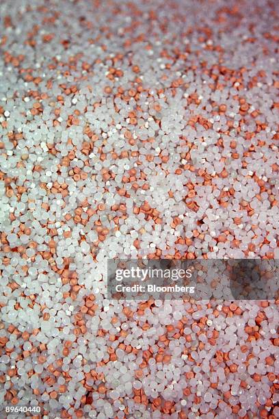 Mixture of raw and recycled plastic resin, or plastic pellets, await processing into plastic bags at Hilex Poly Co.'s manufacturing plant in...