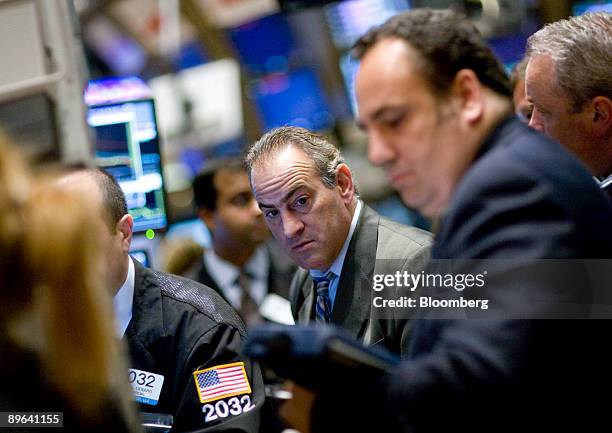 Traders work on the floor of the New York Stock Exchange in New York, U.S., on Thursday, July 2, 2009. U.S. Stocks fell, sending the Standard &...