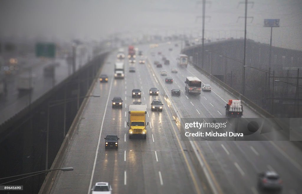 Cars and trucks driving on a highway in weather