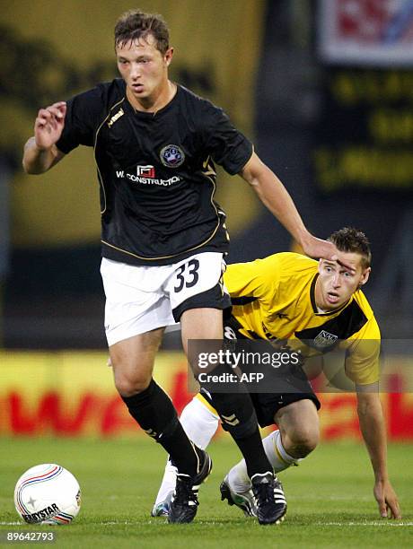 Polonia Warszawa's player Daniel Ciach vies with an unidentified NAC Breda's player during their 3rd round European League qualifying match in Breda,...