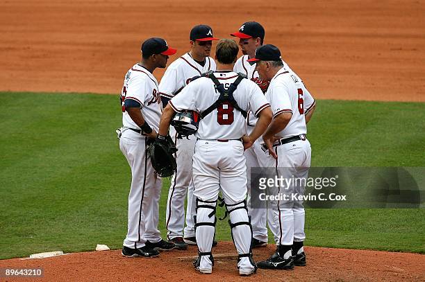 Manager Bobby Cox of the Atlanta Braves talks with Diory Hernandez, Martin Prado, catcher David Ross and Adam LaRoche against the Los Angeles Dodgers...
