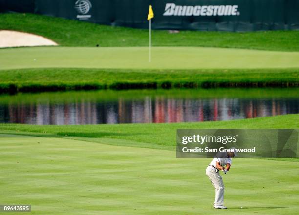 Tiger Woods plays a shot on the 16th hole during the first round of the WGC-Bridgestone Invitational on the South Course at Firestone Country Club on...