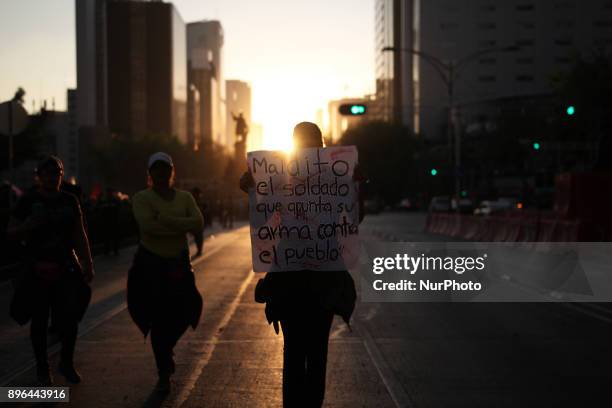 Demonstrator holds a banner while marching to protest against the Law of Internal Security, a law that militarizes crime fighting in the country,...