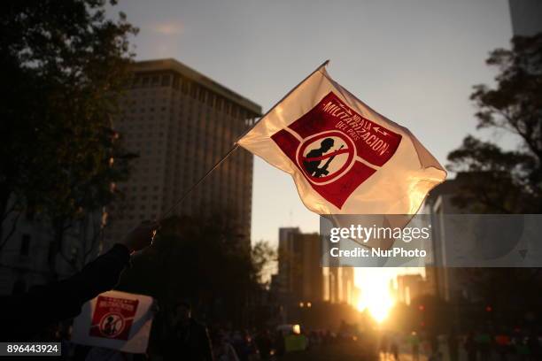 Demonstrator holds a banner while marching to protest against the Law of Internal Security, a law that militarizes crime fighting in the country,...