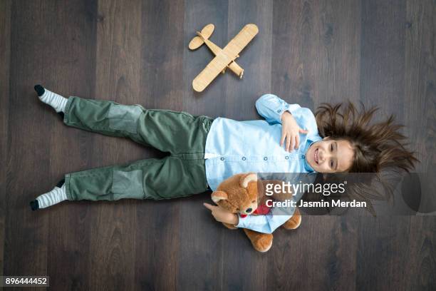 little boy playing with wooden toy airplane - china foto e immagini stock