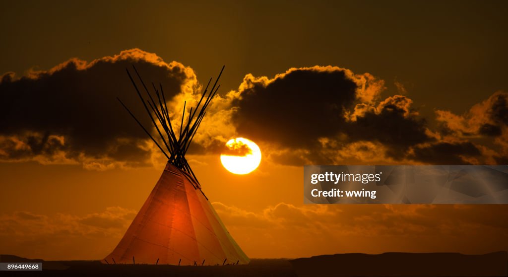 First nation teepee and autumn sunset