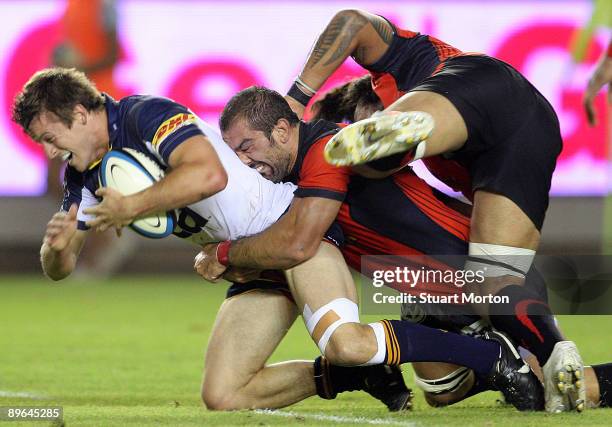 Pat McCabe of the Brumbies is tackled during a pre-season friendly match between Toulon and the Brumbies at Stade Mayol on August 6, 2009 in Toulon,...