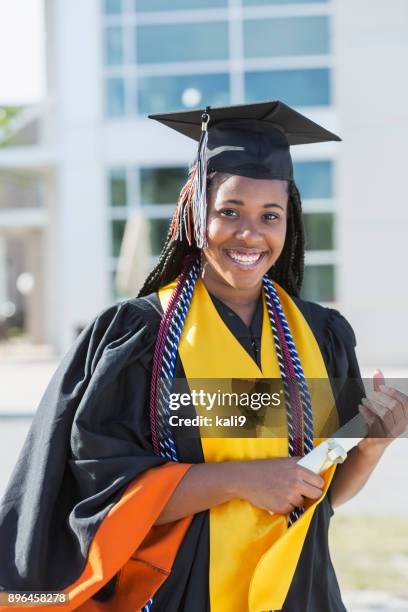 young woman graduating from high school or university - black woman graduation stock pictures, royalty-free photos & images