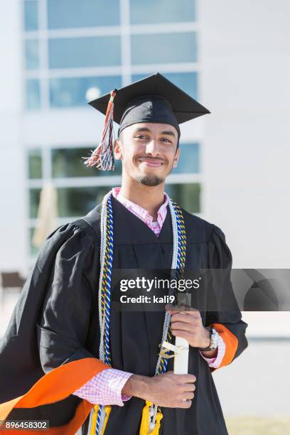 young man graduating from high school or university - convocation stock pictures, royalty-free photos & images