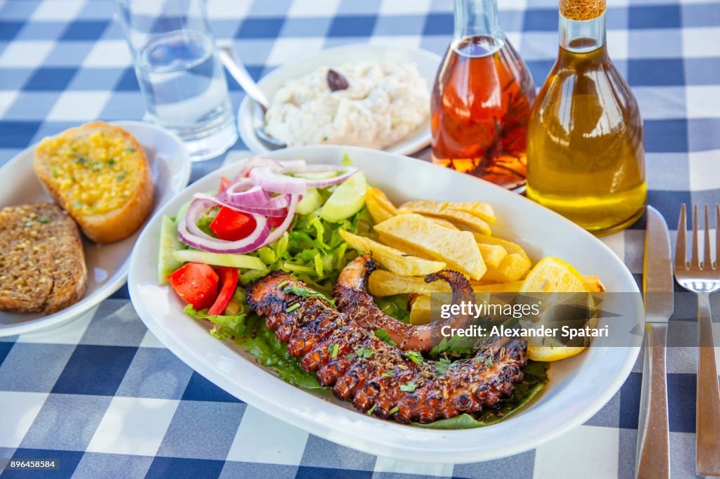 Traditional Greek dinner with grilled octopus and tzatziki