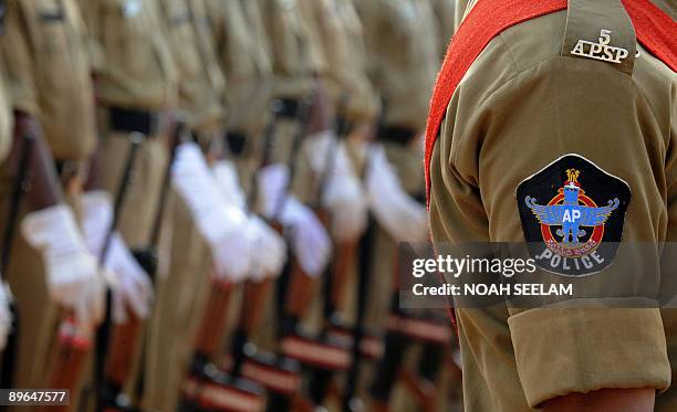 Indian police personnel of the southern Indian State of Andhra Pradesh stand to attention at Parade Grounds in Secunderabad on August 7 during...