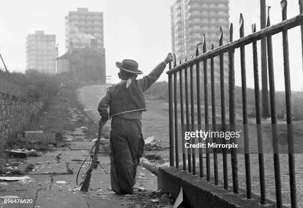 Young boy playing cowboys in Collyhurst, Manchester 14th January 1968 His grandfather knew this street when tiny terraced houses stared at each...