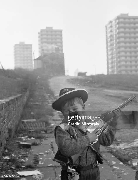 Young boy playing cowboys in Collyhurst, Manchester 14th January 1968 His grandfather knew this street when tiny terraced houses stared at each...