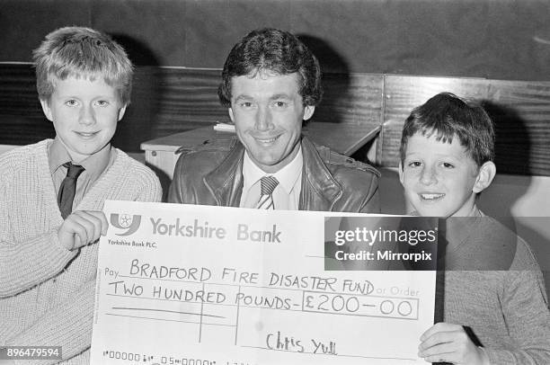Bradford City football manager Trevor Cherry, a former Huddersfield town player who lives at Lepton, is presented with a ú200 cheque for the fire...